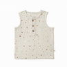 A sleeveless, beige baby vest from Organic Kids with a subtle grid pattern and scattered polka dots. It features three visible buttons and a label on the collar, displayed flat