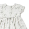 Close-up of a beige Organic Kids Puff Sleeve Dress - Tropical with a palm tree print and ruffled sleeves, displayed on a white background.