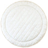 A round, white Organic Cotton Quilted Reversible Play Mat - Dotty and Ivory from Makemake Organics, with a textured surface pattern, framed by a thin, frayed jute border, isolated on a white background.